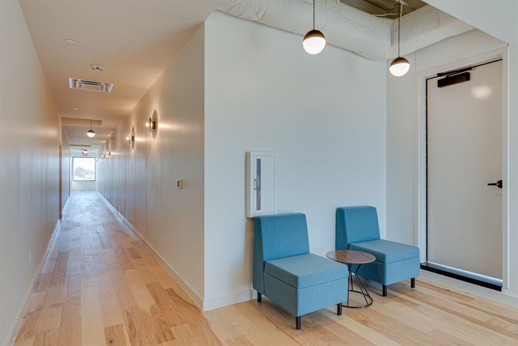 1023 Lipscomb Street, Unit 302 Fort Worth, TX 76104 - Photo 5 of 30 a hallway with furniture and a potted plant