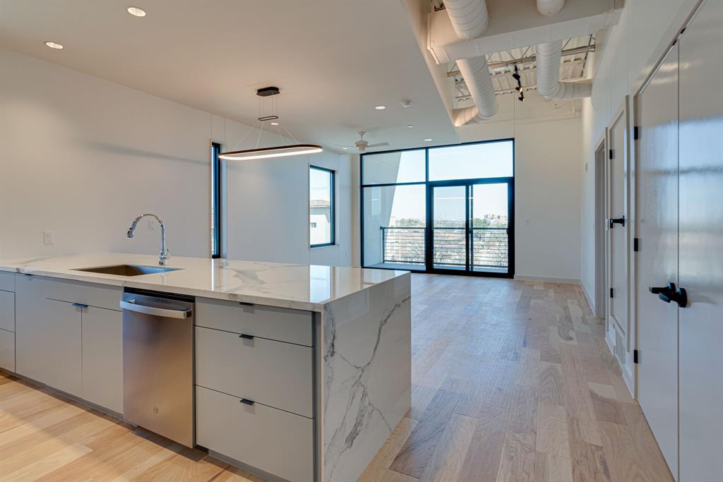 1023 Lipscomb Street, Unit 302 Fort Worth, TX 76104 - Photo 6 of 30 a spacious bathroom with a double vanity sink a large mirror and shower