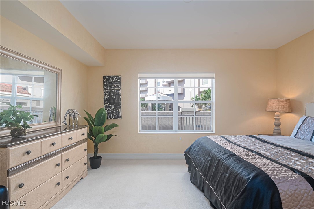 2080 West First Street, Unit 206 Fort Myers, FL 33901 - Photo 11 of 33 a bedroom with a large bed and a window
