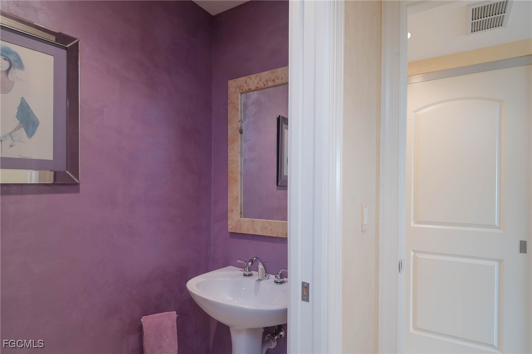 2080 West First Street, Unit 206 Fort Myers, FL 33901 - Photo 14 of 33 a bathroom with a sink and a mirror