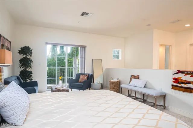 a bedroom with a bed and a large window