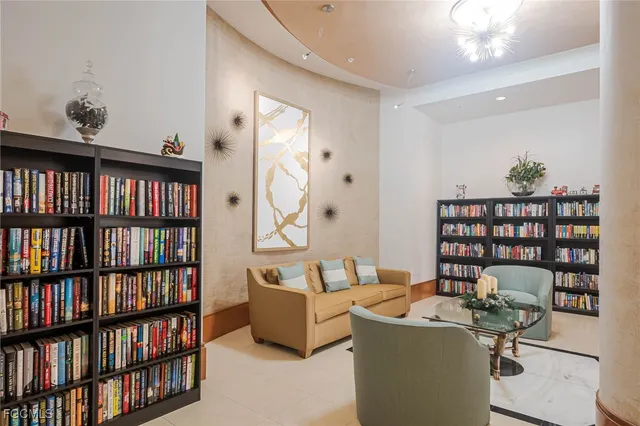 a living room with a book shelf and a book shelf