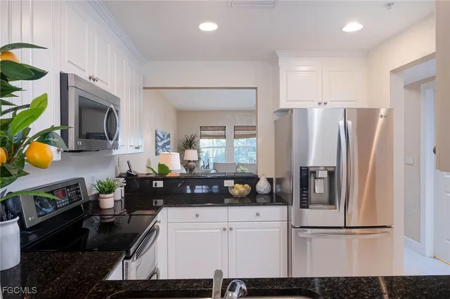 a kitchen with stainless steel appliances a refrigerator a stove a microwave and cabinets