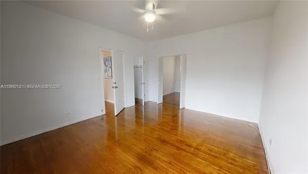 a view of empty room with wooden floor