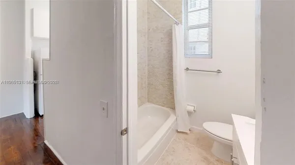 a bathroom with a tub and shower