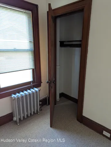 a view of kitchen with furniture and a refrigerator