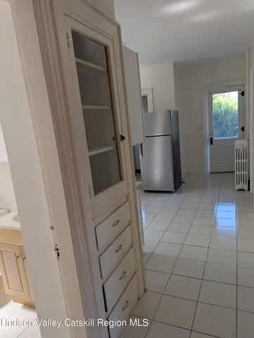 a kitchen with stainless steel appliances a refrigerator a stove a sink and a refrigerator