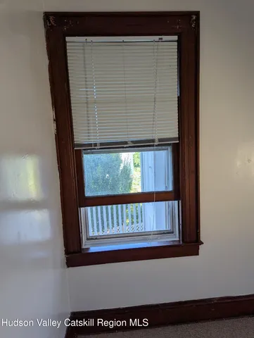 a kitchen with white cabinets and a white stove