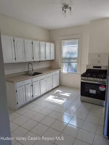 a view of a hallway with stairs and a window
