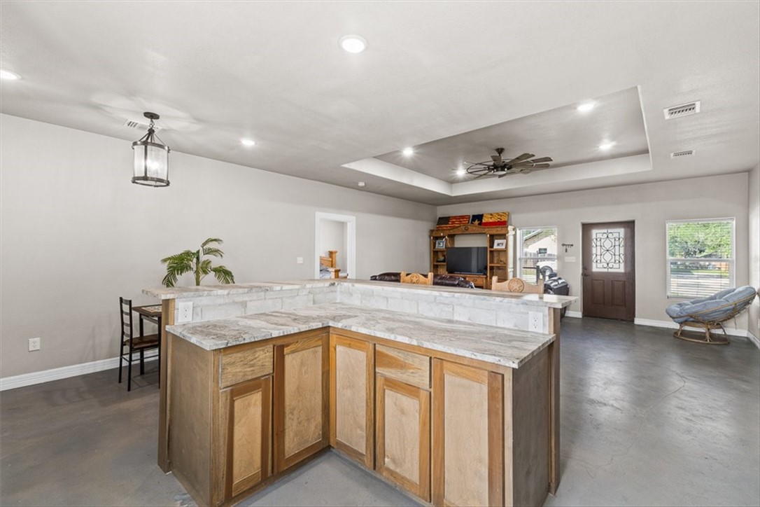 207 South Charles Street George West, TX 78022 - Photo 13 of 24 a kitchen with a stove and a refrigerator