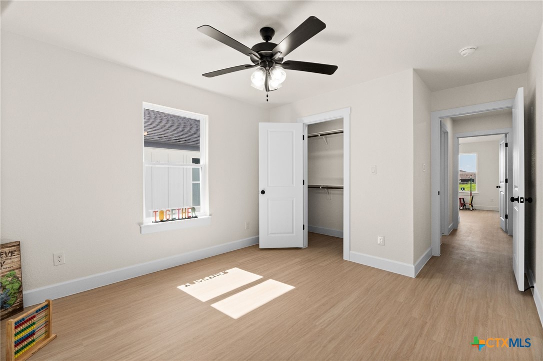 2115 Blackhawk Loop Belton, TX 76513 - Photo 22 of 26 wooden floor in an empty room with a window