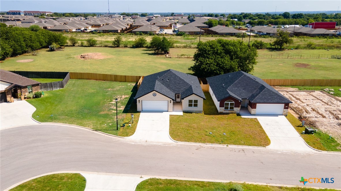 2115 Blackhawk Loop Belton, TX 76513 - Photo 3 of 26 an aerial view of a house with a garden and lake view