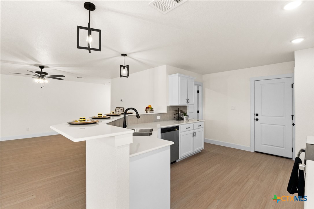 2115 Blackhawk Loop Belton, TX 76513 - Photo 8 of 26 a kitchen with a sink cabinets and wooden floor