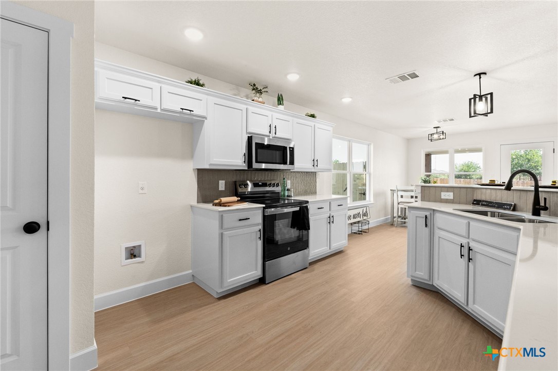 2115 Blackhawk Loop Belton, TX 76513 - Photo 9 of 26 a kitchen with granite countertop a refrigerator and a stove top oven