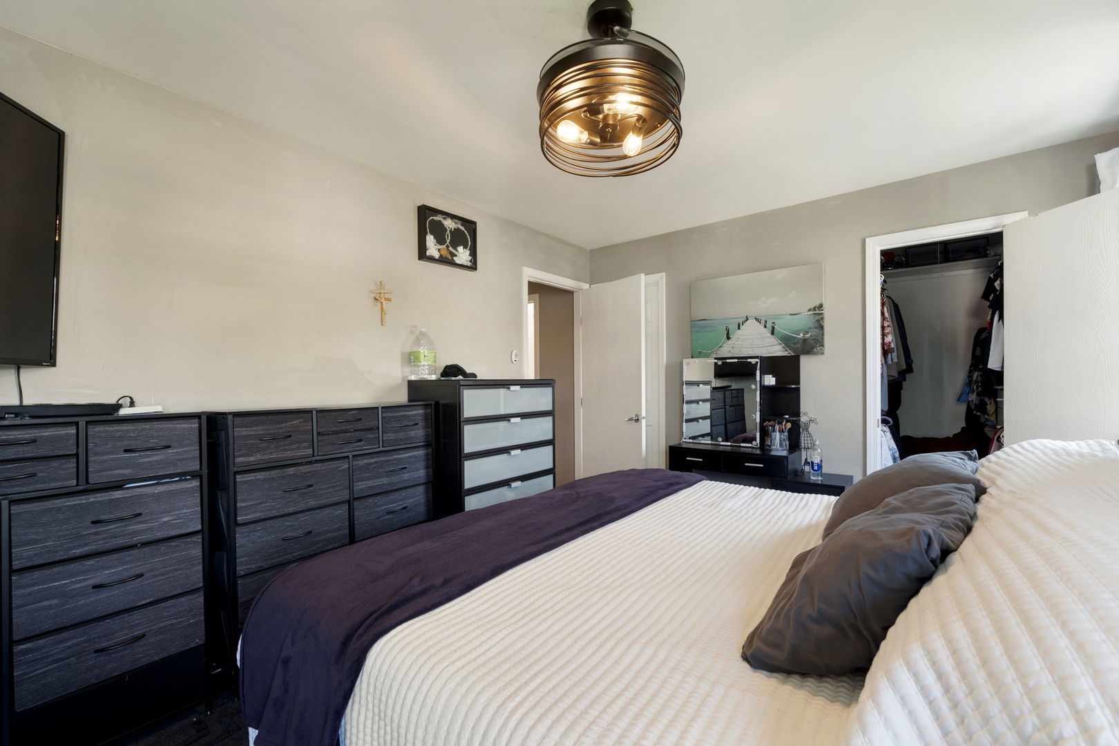 24 Fillmore Lane Streamwood, IL 60107 - Photo 18 of 35 a bedroom with a bed and a chandelier