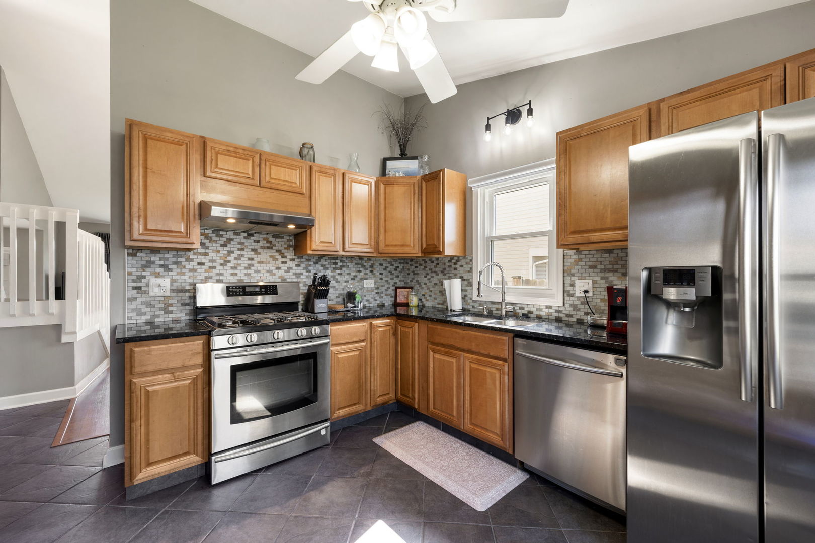 24 Fillmore Lane Streamwood, IL 60107 - Photo 8 of 35 a kitchen with stainless steel appliances granite countertop a refrigerator a stove and a sink with wooden floor