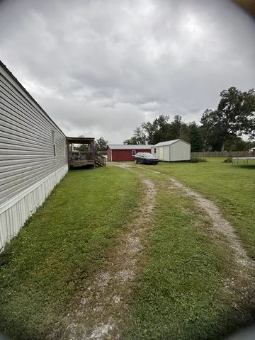 a view of a yard with a tree