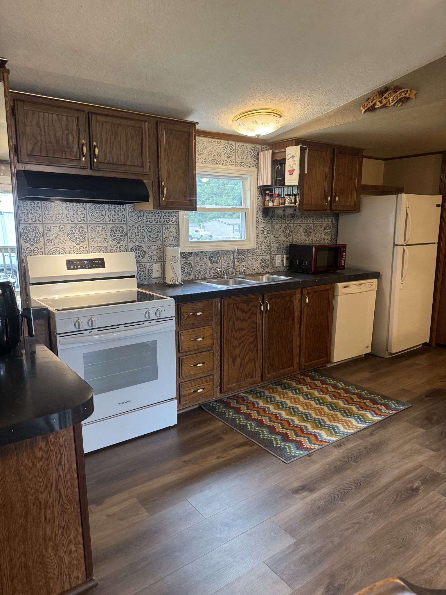 79 Sharps Lane Beechgrove, TN 37018 - Photo 9 of 29 a kitchen with granite countertop wooden cabinets a stove and a sink