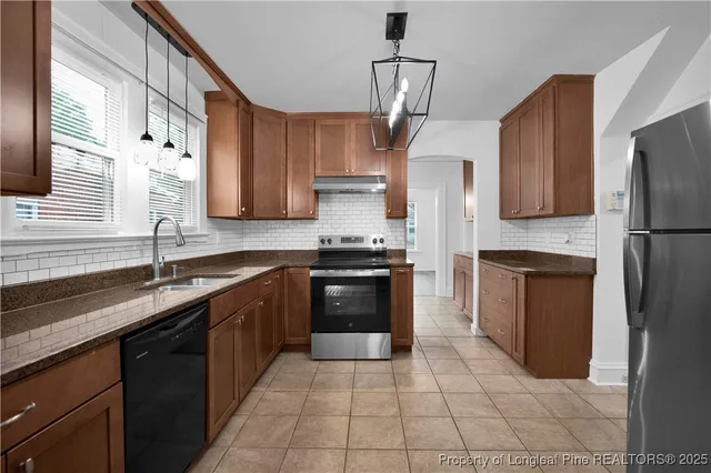 a kitchen with a sink stove and refrigerator