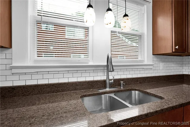 a kitchen with a sink and a window