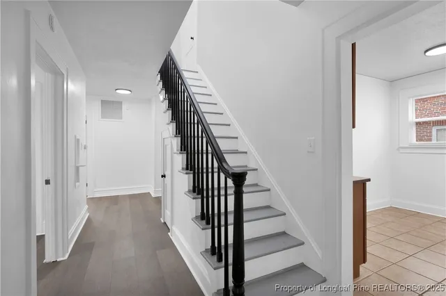 a view of a hallway with wooden floor and entryway