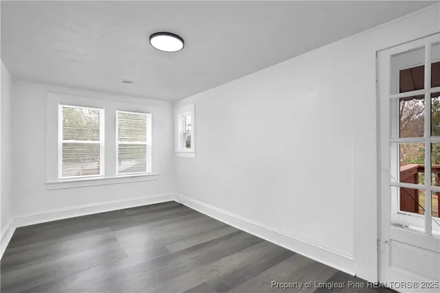 an empty room with windows and entrance