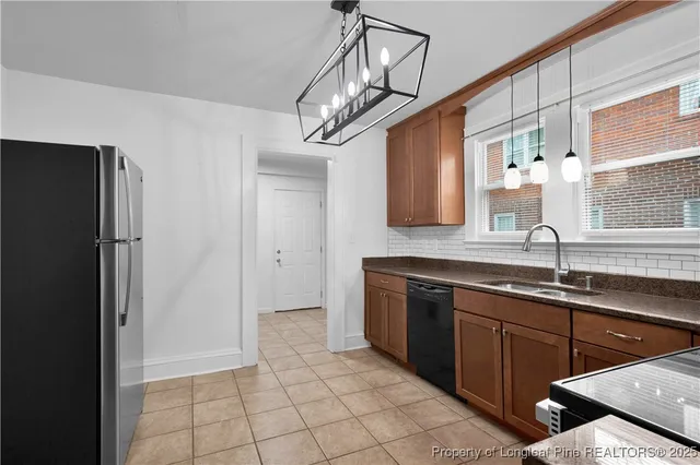 a kitchen with a sink stainless steel appliances and cabinets