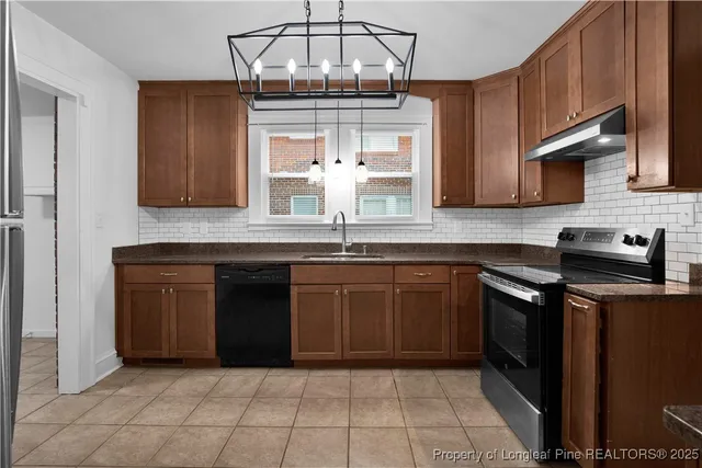 a kitchen with stainless steel appliances granite countertop a sink and cabinets