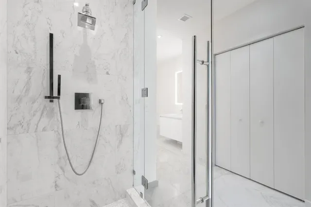a bathroom with a shower and a glass door