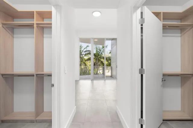 a view of walk in closet with empty racks