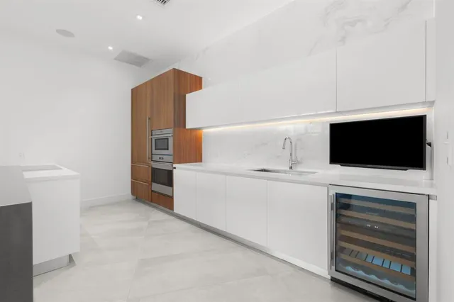 a utility room with cabinets dryer and washer