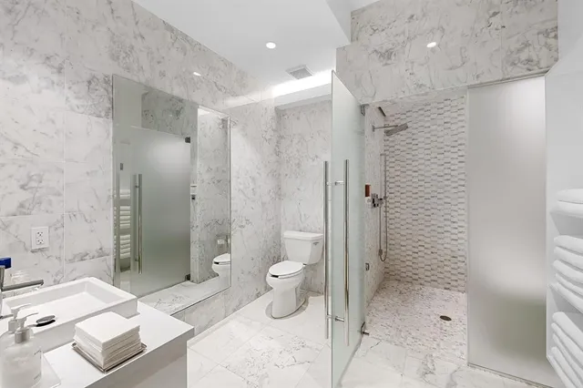 a bathroom with a bathtub sink and mirror
