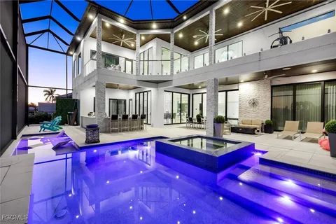 a living room with patio pool table and chairs