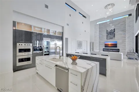 a kitchen that has a lot of cabinets in it and appliances