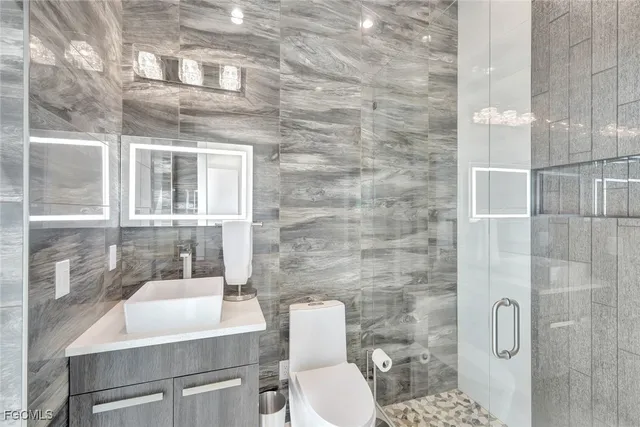 a bathroom with a toilet and shower