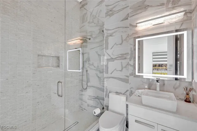 a bathroom with a toilet sink and shower