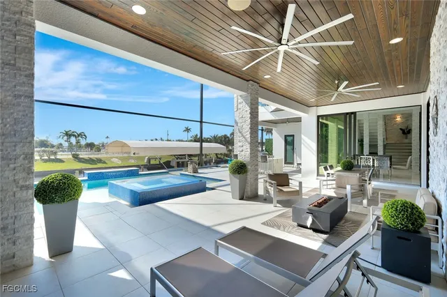 a living room with fireplace furniture and a potted plant
