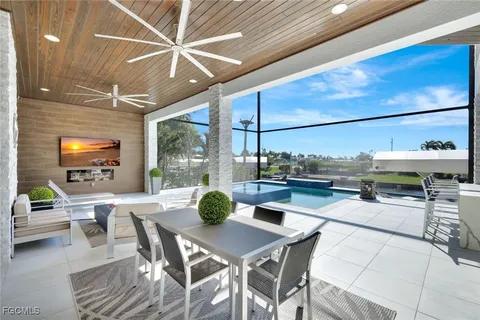 a view of a dining room with furniture and a floor to ceiling window