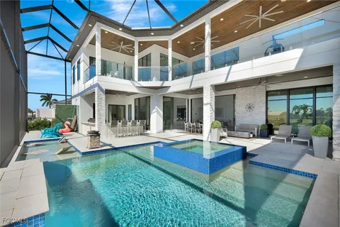 a view of a house with a yard patio and fire pit