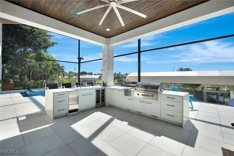 a kitchen that has a lot of white cabinets