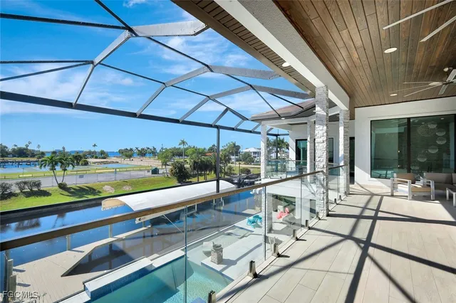 a view of a patio with a dining table and chairs with wooden floor