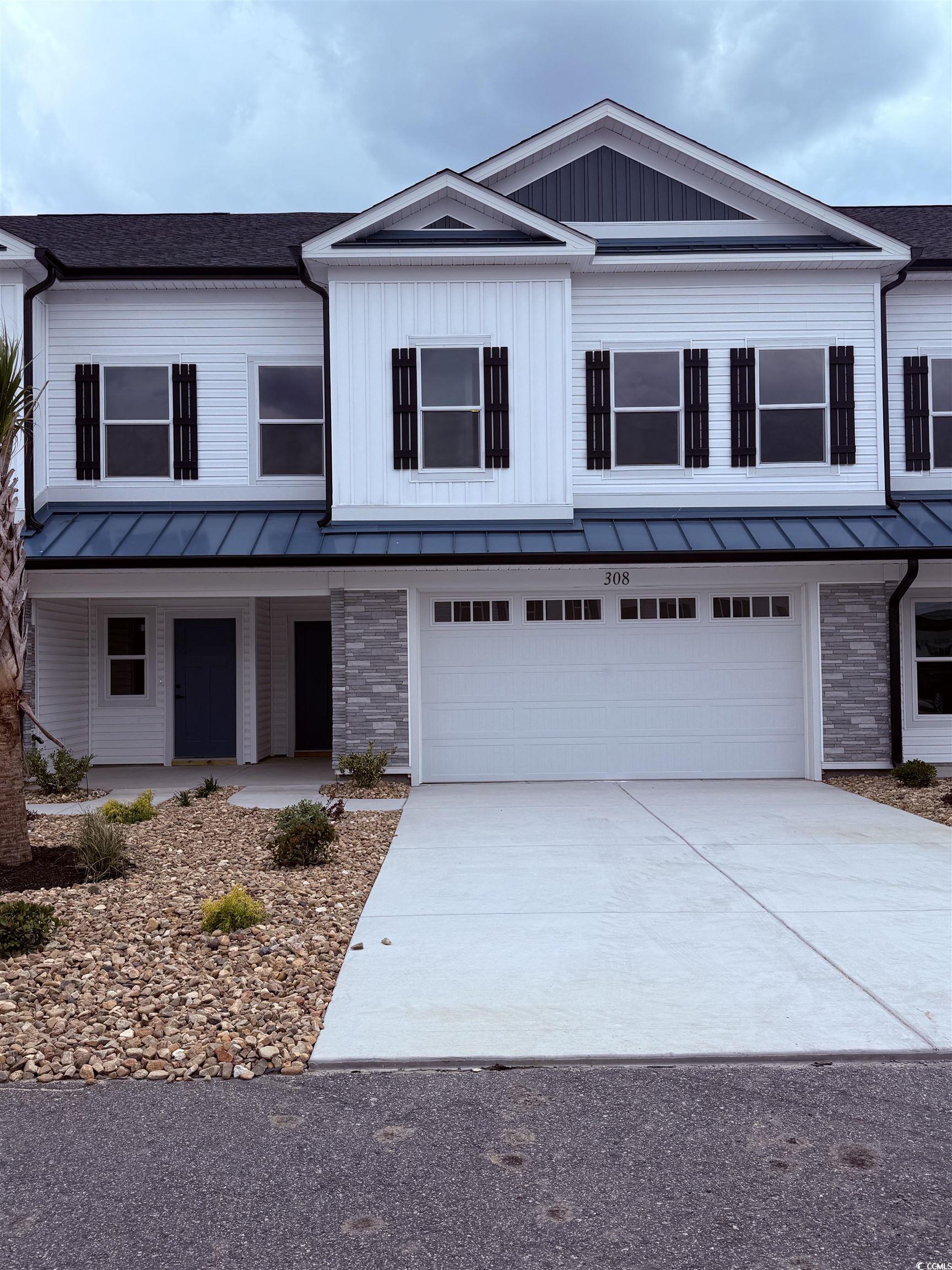 308 Lineback Place, Unit 308 Longs, SC 29568 - Photo 1 of 5 View of front facade with a garage, a porch, drive