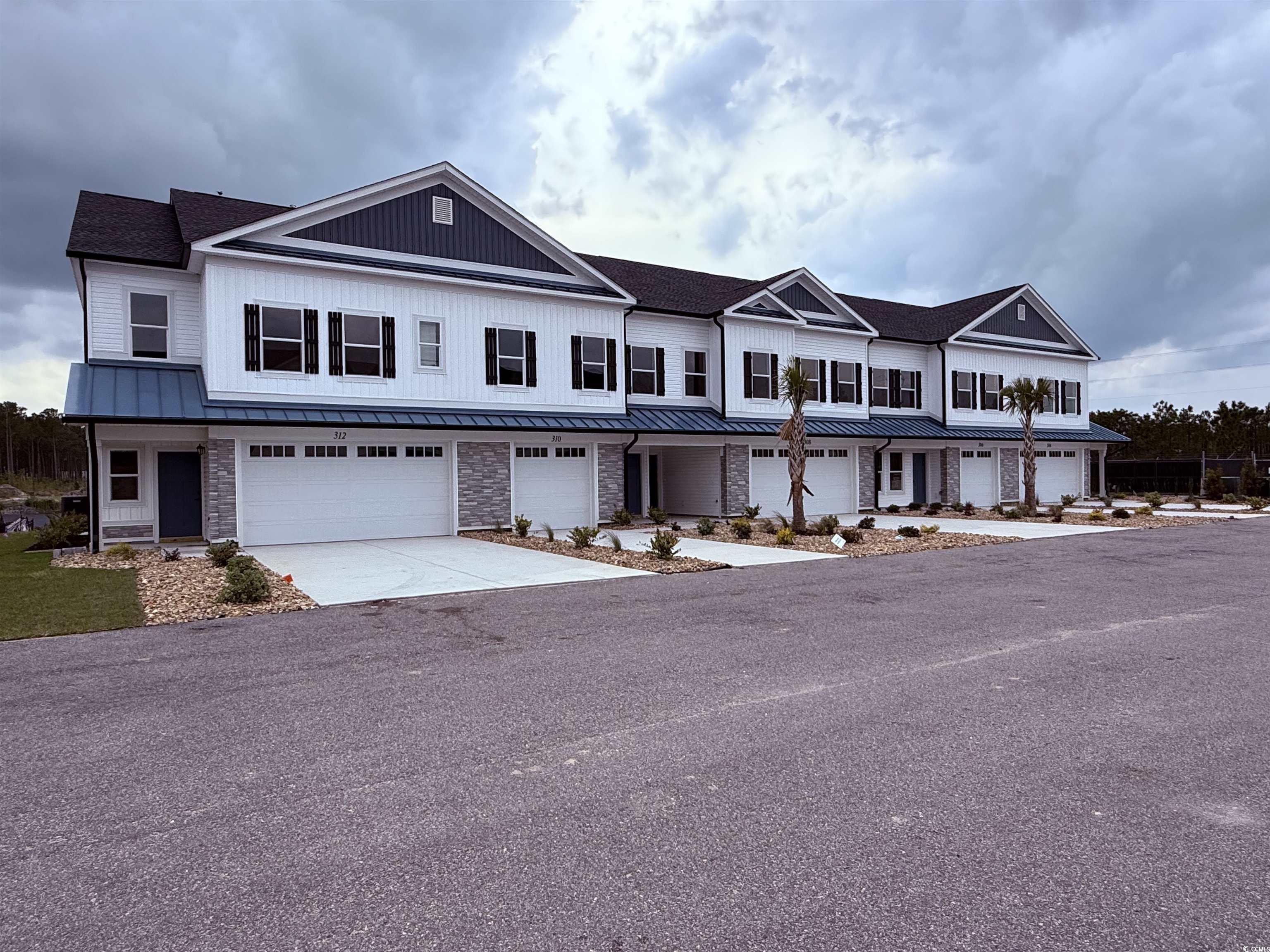 308 Lineback Place, Unit 308 Longs, SC 29568 - Photo 2 of 5 View of property featuring a standing seam roof, a