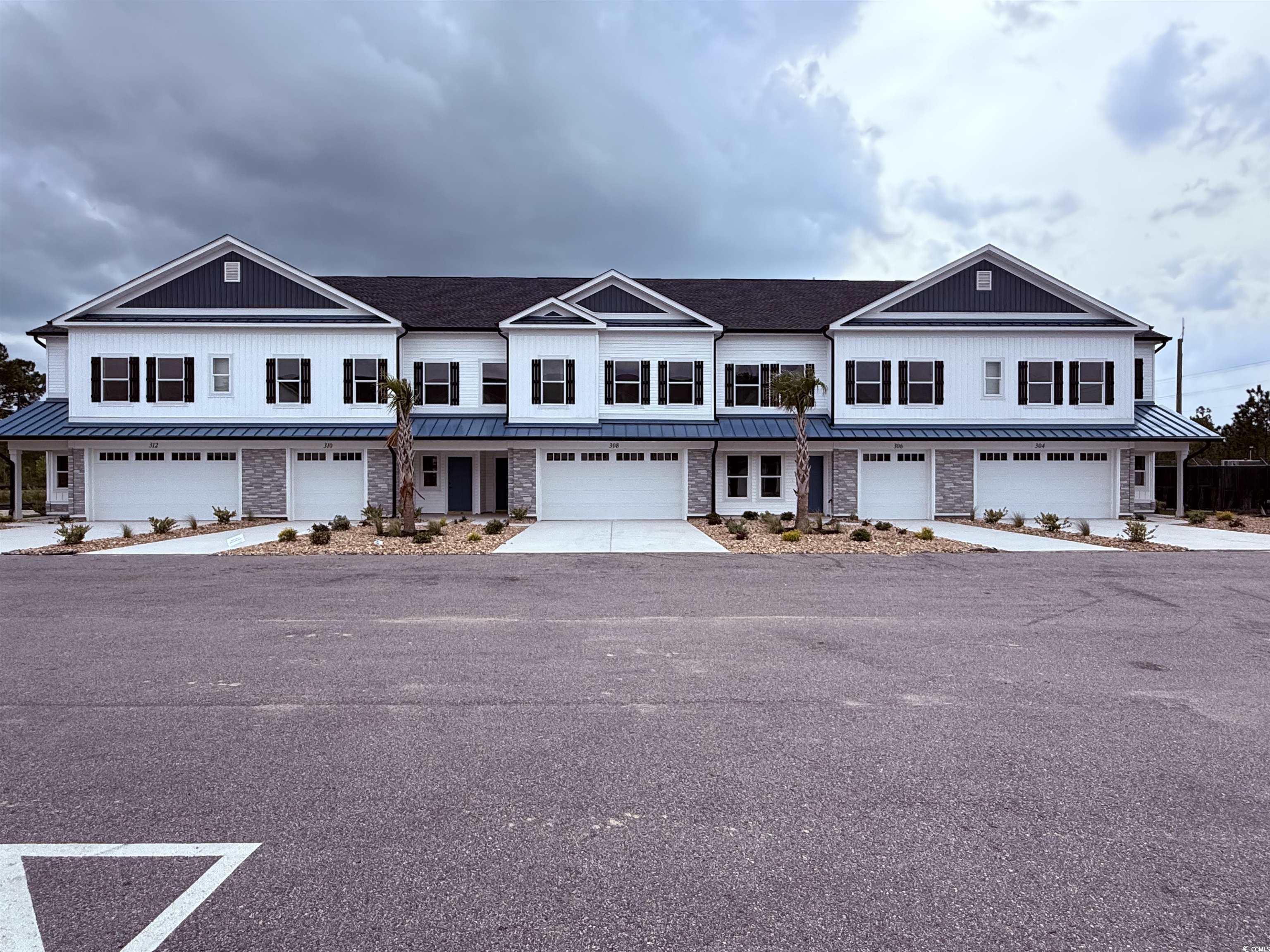 308 Lineback Place, Unit 308 Longs, SC 29568 - Photo 3 of 5 View of property featuring driveway, metal roof, a