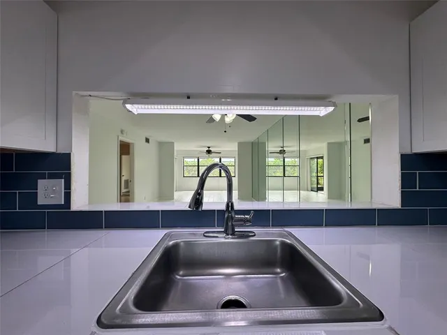 a view of a livingroom with a furniture and chandelier fan