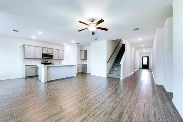 a view of a kitchen with wooden floor and a kitchen