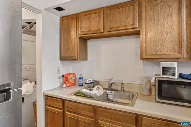 a kitchen with stainless steel appliances granite countertop a sink dishwasher stove and cabinets
