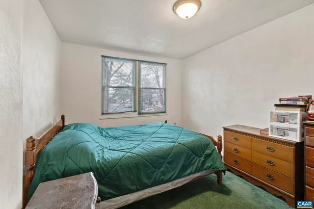 a bedroom with bed and a closet