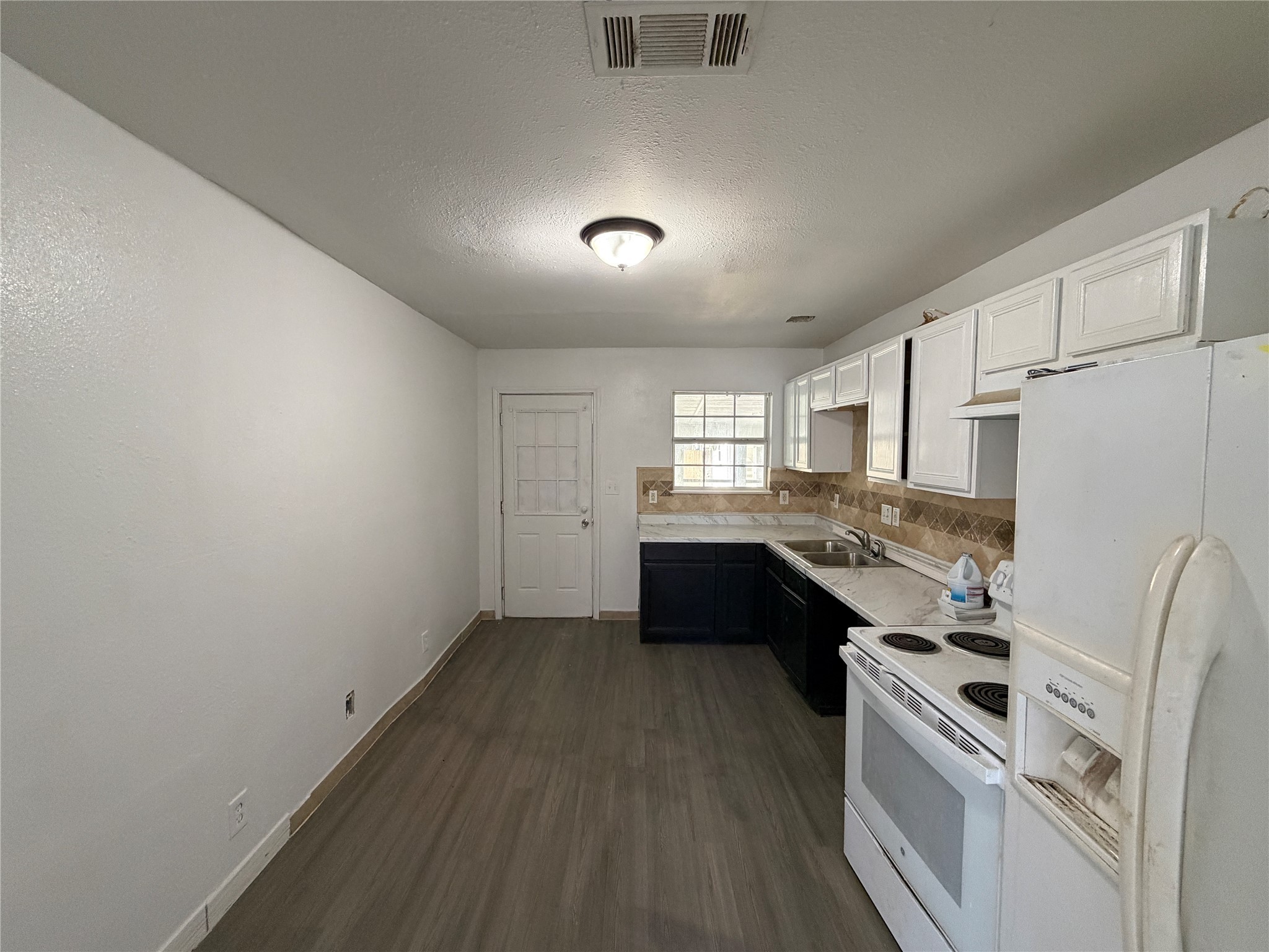 7606 Darnay Drive Houston, TX 77033 - Photo 8 of 11 a kitchen with a stove a refrigerator and a sink