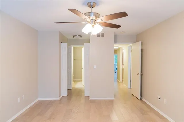 wooden floor in an empty room with a fan